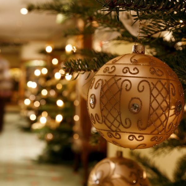 Detailaufnahme einer goldenen Christbaumkugel mit Glitzerverzierung 