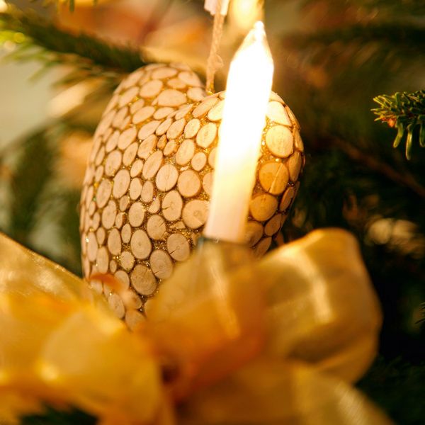 Nahaufnahme von Christbaumschmuck und Kerzen, in einem Christbaum hängen