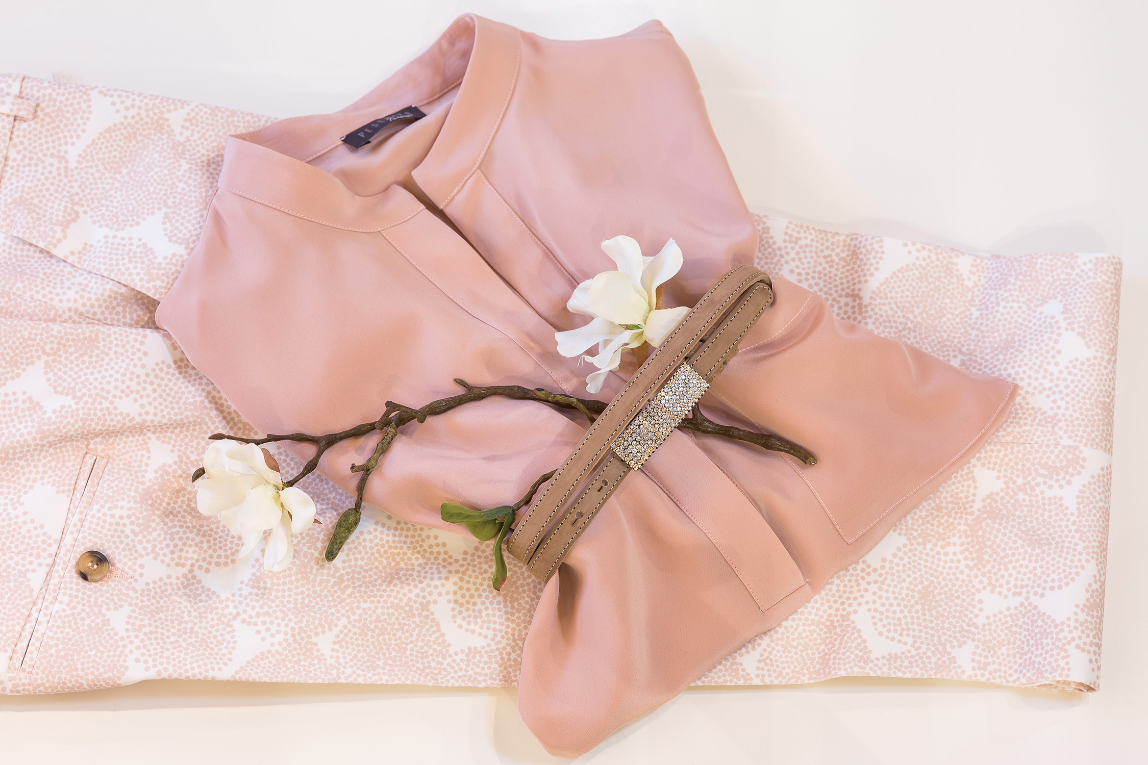 Detailaufnahme eines rosaroten Oberteils in der Modebotique des Luxushotels Schwarzwald